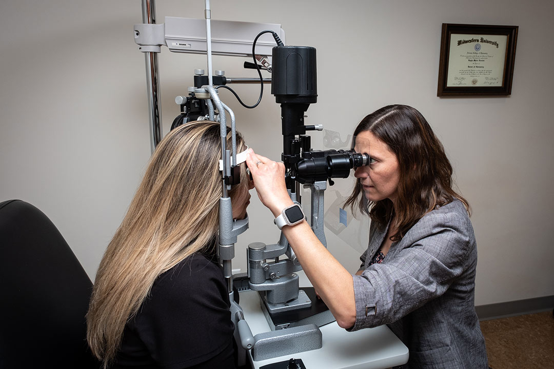 Longmont eye care physicians & vison center nurse doing eye x=exam on patient photo